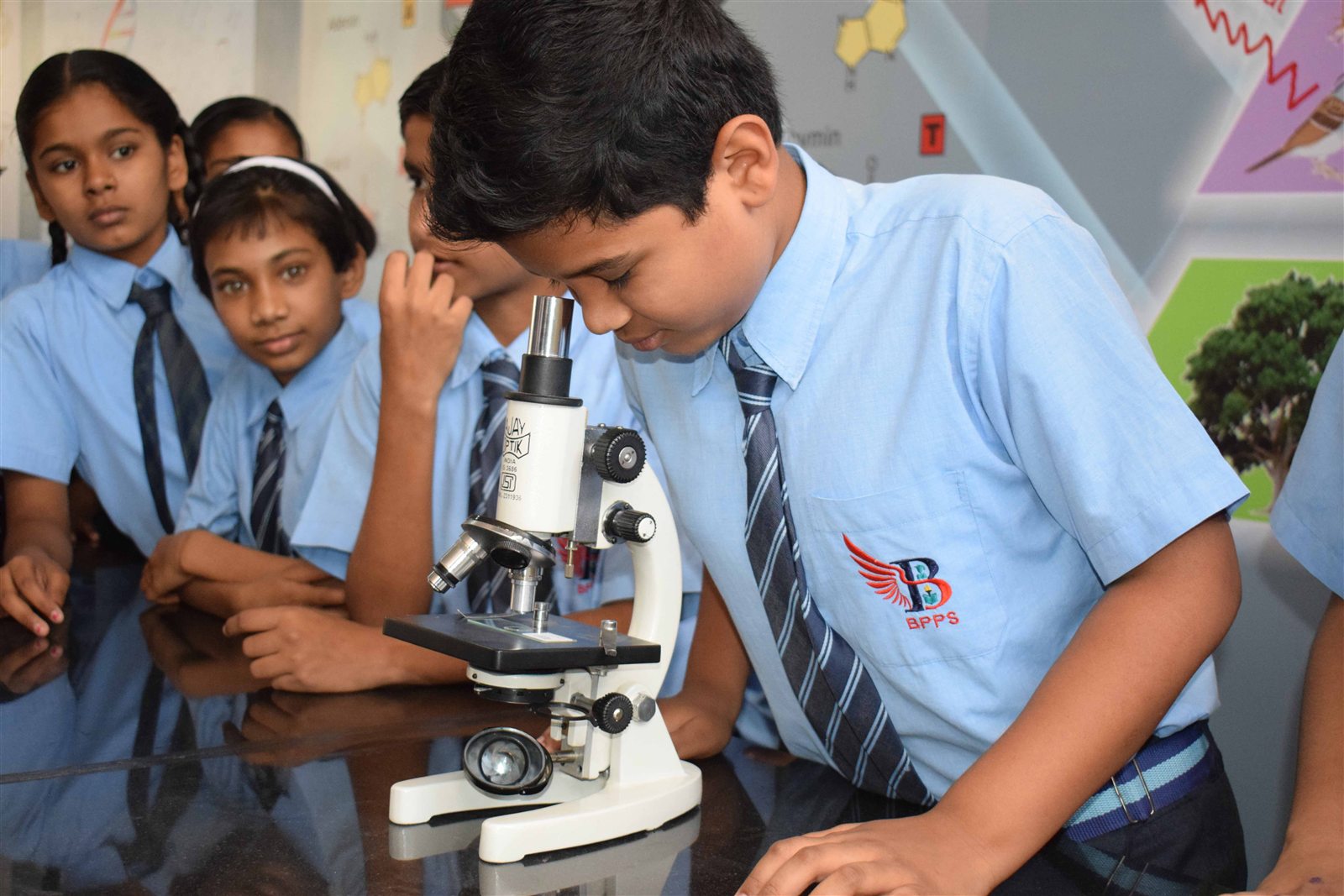 BPPS student using a microscope in the science laboratory